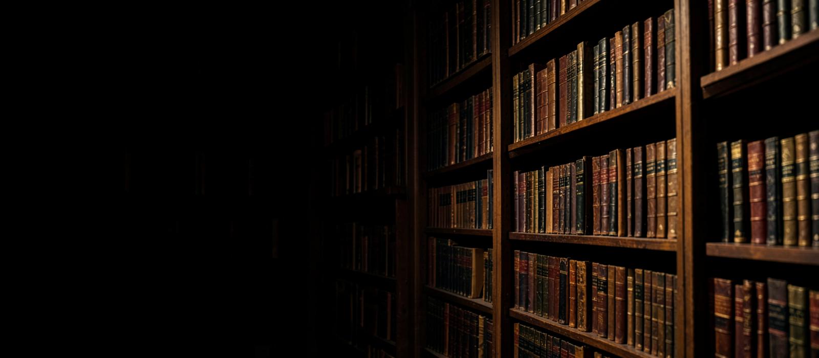 Shelves of antique leather-bound books in a dark library